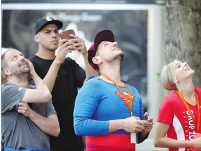ABOVE: The Easter Seals drop zone fundraiser draws all eyes, including those of a man in a Superman costume, at the Carleton Tower on Monday.