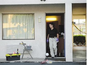 An Albuquerque Police Department officer collects evidence Wednesday at a Motel 6. A cross-country road trip got derailed for former CBC anchor Lynne Russell and her husband after a would-be robber forced his way into their motel room and a shootout ensued.