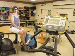 Allison Cameron, a resource teacher at Evan Hardy Collegiate, sits in her classroom that is equipped with exercise machines for students.
