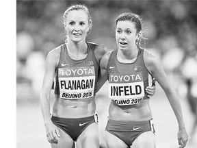 Americans Shalane Flanagan, left, and Emily Infeld walk arm in arm after the women's 10,000m final at the World Athletics Championship in Beijing on Monday.