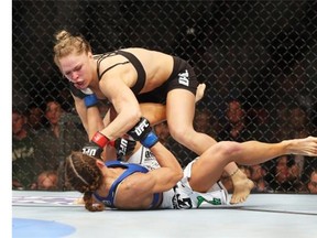 ANAHEIM, CA - FEBRUARY 23:  Ronda Rousey hits Liz Carmouche during their UFC Bantamweight Title fight at Honda Center on February 23, 2013 in Anaheim, California.  (Photo by Jeff Gross/Getty Images)