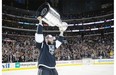 Los Angeles Kings defenceman Robyn Regehr carries the Stanley Cup after beating the New York Rangers