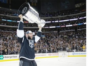 Los Angeles Kings defenceman Robyn Regehr carries the Stanley Cup after beating the New York Rangers