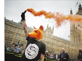 An anti-fox hunt protester demonstrates Tuesday in London. Prime Minister David Cameron's Conservative government's proposed legislation relaxing the ban on fox hunting in England and Wales was postponed after the Scottish National Party said it will vote against the motion.