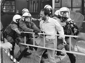 An anti-EU protester scuffles with police in Athens on Thursday. Greek Prime Minister Alexis Tsipras has urged Greeks to vote no to the austerity measures in Sunday's referendum.