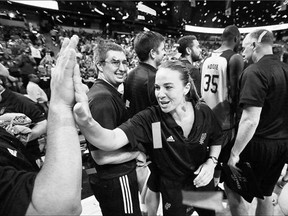 San Antonio Spurs' coach Becky Hammon celebrates with her team after they defeated the Phoenix Suns to win the NBA summer league championship. She is helping pave the way for women coaches in pro sport.