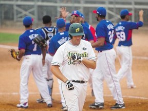 Australia infielder James Brownlow leaves the field after he and his team are defeated by team Dominican Republic during the Men's World Softball Championships at Bob Van Imp park on Monday.
