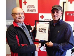 Barry Salmond (left) of the Red Cross presented an award to Saskatoon man Aaron Jackson on Oct. 22, 2015 (Jonathan Charlton / The StarPhoenix)