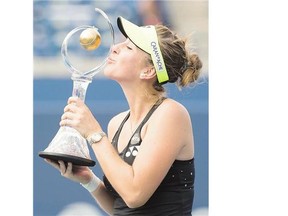 Belinda Bencic poses with winner's trophy after defeating Simona Halep, of Romania, in the women's final at the Rogers Cup in Toronto Sunday.