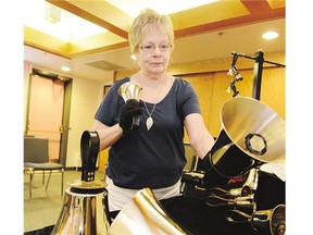 Betty Alexander, director-conductor of Bronze Reflections, demonstrates the techniques required to successfully play the handbells.