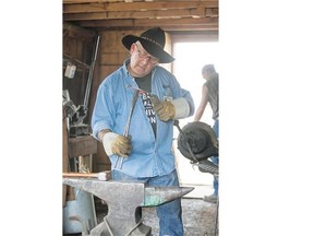 Blacksmiths work during Pion-Era at the Western Development Museum on Sunday.