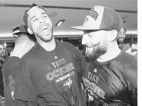 Blue Jays' David Price, left, and Kevin Pillar celebrate in the clubhouse after clinching a wild-card spot in the playoffs after their win against the Tampa Bay Rays Saturday.