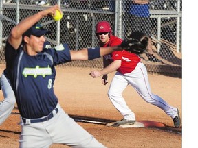 Brad Ezekiel of Team Canada, right, gets ready to take off from first base as pitcher Jorge Segura of Team Guatemala delivers in the 14th Men's World Softball Championship in Saskatoon Friday.