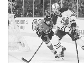 Brandon Bollig, left, of the Calgary Flames chases Justin Schultz of the Edmonton Oilers during a pre-season NHL game at Scotiabank Saddledome earlier this week.