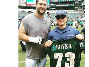 Brett Boyko gives a member of the Coast Guard his jersey after practice on a special day to honour the Coast Guard. Submitted photo.