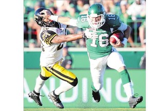 Brett Smith, right, shown trying to elude the Hamilton Tiger-Cats' Emanuel Davis on Sunday, is to start at quarterback Friday for the Roughriders.