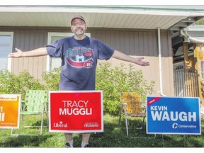 Brian Krzyzaniak can't decide who to vote for in the federal election and has signs for three candidates on his lawn.