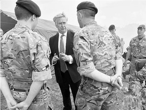 British Defence Secretary Michael Fallon speaks with U.K. instructors near Zhytomyr, west of Kyiv, on Tuesday.