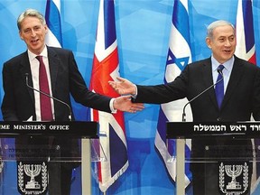 British Foreign Secretary Philip Hammond, left, and Israeli Prime Minister Benjamin Netanyahu share their divergent views on the deal with Iran Thursday in Jerusalem.