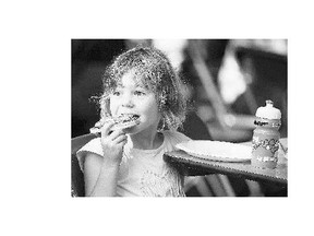 Brookie Jocelyn enjoys pizza at A Taste of Saskatchewan in Saskatoon. The festival, which runs till July 19 in Kiwanis Park, features fare from some of the city's finest restaurants.