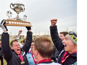 Bryce Chapman hoists the trophy as the University of Saskatchewan Huskies celebrate their first Canada West Soccer Championship in November 2014.