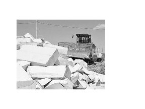 A bulldozer crushes boxes of cheese outside the city of Belgorod on Thursday.