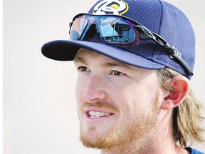 Burlington Bees outfielder Trevor Gretzky waits to take the field before a minor league baseball game in Clinton, Iowa. Gretzky is toiling in relative anonymity playing in Class-A.