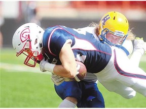 Calgary Colts' Dylan Minshull hangs onto the ball as he dives over the goal line with Hilltops' Cole Benkic trying to prevent him on Sunday in Calgary. Both teams were tied at halftime, but Saskatoon dominated the second half en route to a 31-10 victory.
