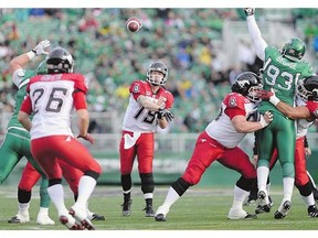 Calgary quarterback Bo Levi Mitchell, centre, led an offence that made key plays at crucial stages against the Riders Saturday.