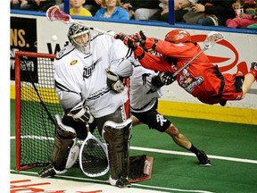 Calgary Roughnecks forward Curtis Dickson, right, shoots and scores on Edmonton Rush goalie Aaron Bold during National Lacrosse League West Division Final game action in Edmonton in May 2014.