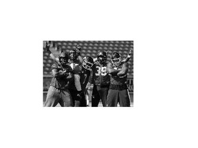 Calgary Stampeders, from left, Freddie Bishop III, Juwan Simpson, Junior Turner, Charleston Hughes and Micah Johnson hammed it up during practice Thursday. The team is busy preparing for the Labour Day Classic on Monday against Edmonton.