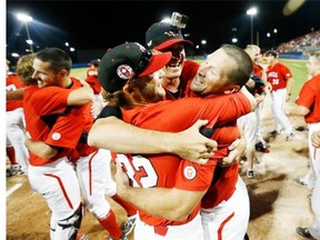 Canada athletes celebrate after beating the United States 7-6 in the 10th inning of the gold medal baseball game at the Pan Am Games, Sunday, July 19, 2015, in Ajax, Ontario.