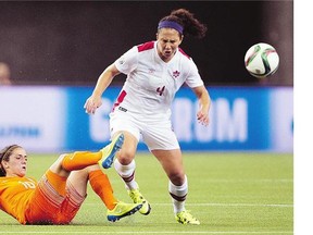 Canada's Carmelina Moscato battles Netherlands' Danielle van de Donk in Montreal earlier in the tournament. Moscato said her conversation was misrepresented when a Fox analyst and former member of Team Canada reported morale was low on the Canadian team.