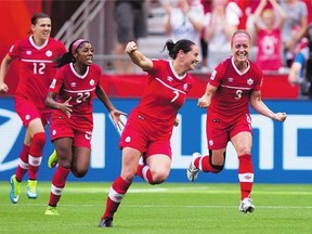 Canada's Christine Sinclair, from left, Ashley Lawrence, Rhian Wilkinson and Josee Belanger celebrate Belanger's goal against Switzerland in Vancouver Sunday night.