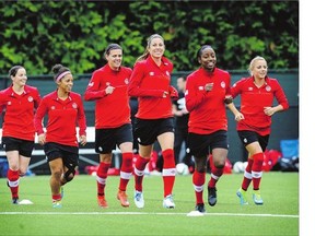 Canada's Christine Sinclair, third from left, and other Canadian players prepare for their pressure-packed showdown against the Swiss on Sunday afternoon.