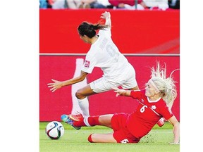 Canada's Kaylyn Kyle defends against New Zealand's Amber Hearn during FIFA Women's World Cup soccer action in Edmonton June 11.