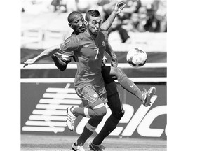 Canada midfielder Russell Teibert vies for the ball with Martinique defender Nicolas Zaire, left, during a Gold Cup match in 2013.