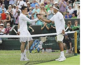 Canada's Milos Raonic, left, congratulates Nick Kyrgios of Australia following third-round singles action at Wimbledon on Friday. Kyrgios won the match in four sets.