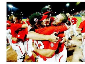 Canada players celebrate after beating the United States 7-6 in the 10th inning of the gold medal baseball game at the Pan Am Games on Sunday in Ajax, Ont. The Americans had scored two runs in the top of the inning.
