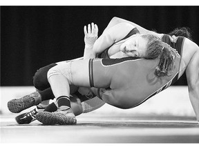 Canadian Dori Yeats, left, battles Venezuela's Maria Acosta in the women's 69kg freestyle wrestling at Pan American Games. Yeats won the match - and the gold.