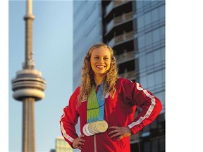 Canadian Ellie Black proudly displays the five medals she won at the women's artistic gymnastics competitions during the Pan Am Games in Toronto.