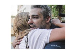 Canadian journalist Mohamed Fahmy hugs his wife Marwa following his release from prison. Fahmy and his colleague Baher Mohamed were pardoned by Egyptian President Abdel Fattah al-Sisi on Wednesday.