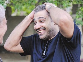Canadian journalist Mohamed Fahmy reacts after being dropped off by authorities in the Cairo suburb of Maadi following his release from prison with his colleague Baher Mohamed after being pardoned by Egyptian President Abdel Fattah al-Sisi.