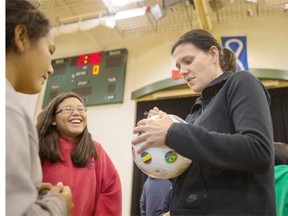 Canadian women’s soccer player Christine Sinclair signs autographs for students at the school in Ile a la Crosse on Monday, Oct. 5, 2015.