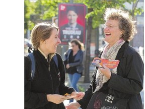 NDP candidate for Papineau, Anne Lagace Dowson, right, speaks with passerby Florence Lavoie-Cote while campaigning in the Montreal riding on Wednesday. She is hoping to unseat the incumbent, Liberal party leader Justin Trudeau.