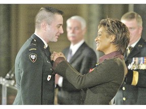 The sex charges against Lt.-Col. Mason Stalker, shown receiving the Meritorious Service Medal in Ottawa by then-governor general Michaelle Jean in this 2007 file photo, are yet another hit to the reputation of the Canadian Forces, which is reeling from allegations of widespread sexual harassment and assault.