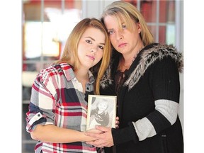 Cheyenne Dunbar and her mother Terry Dunbar hold a photo of Cheyenne's two-year-old daughter Hailey Dunbar-Blanchette who was found dead following an abduction on Tuesday.