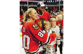 Chicago forward Patrick Kane celebrates the team's cup win Monday night with the family of former Blackhawks equipment manager Clint Reif, who died at home in December.