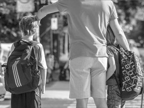 Children arrive for the first day of school in Montreal last week. Modern schools now require more equipment from youngsters and their families, such as an easily breakable $600 iPad.