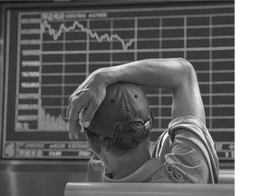 A Chinese day trader watches a stock ticker Thursday in Beijing. China may have bought shares in big companies to stabilize prices.